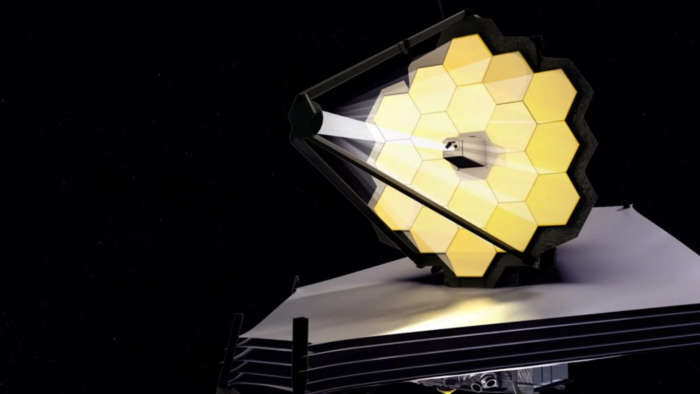 The James Webb Space Telescope deployed in space — 18 gold-coated hexagonal primary mirror segments catching starlight above the multi-layer sun shield